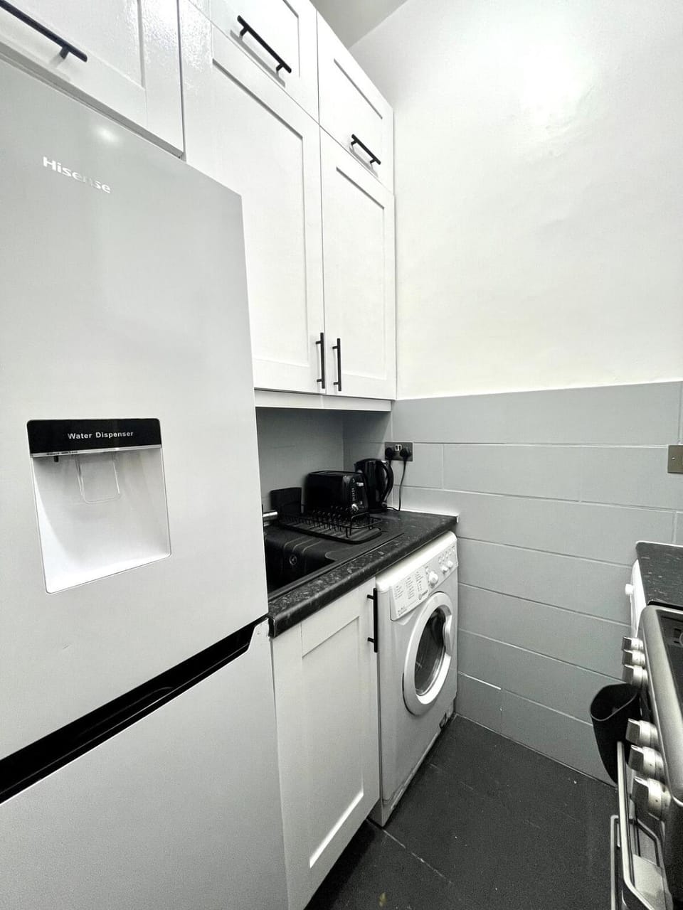 Kitchen or kitchenette, oven, stove, toaster, washing machine