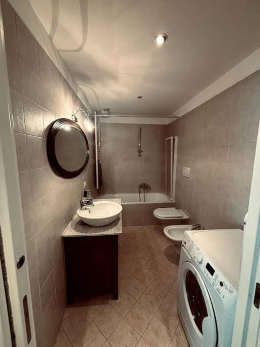 Toilet, Bathroom, bidet, towels, washing machine, dryer