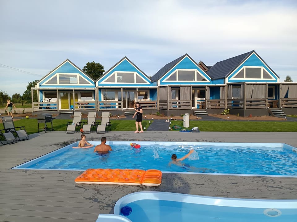 Property building, Pool view, Swimming pool, group of guests, sunbed