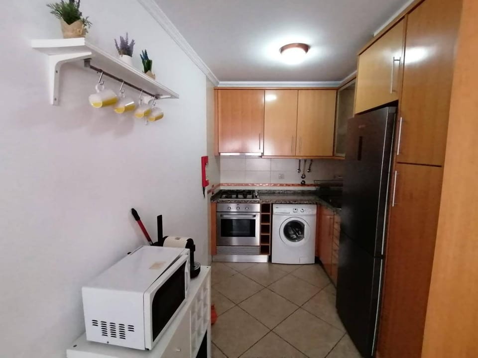 Kitchen or kitchenette, stove, washing machine