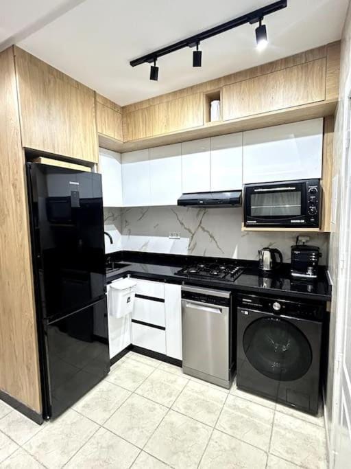 Kitchen or kitchenette, dishwasher, oven, stove, toaster, washing machine