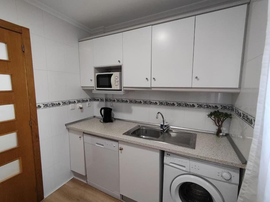 Kitchen or kitchenette, dishwasher, stove, toaster, washing machine
