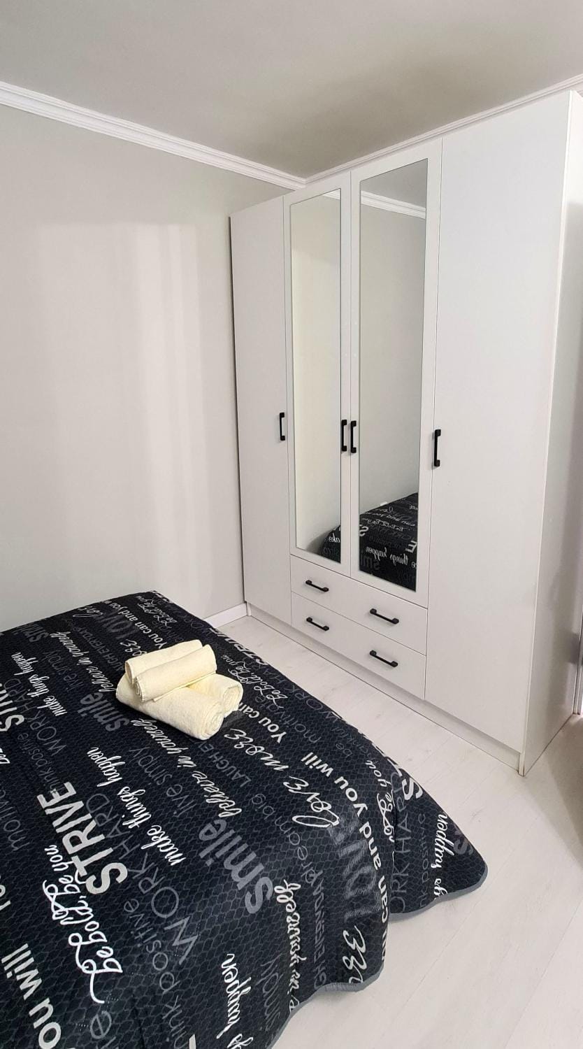 Bed, towels, wardrobe