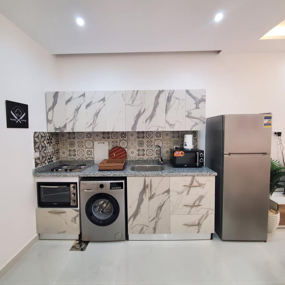 Kitchen or kitchenette, oven, stove, washing machine