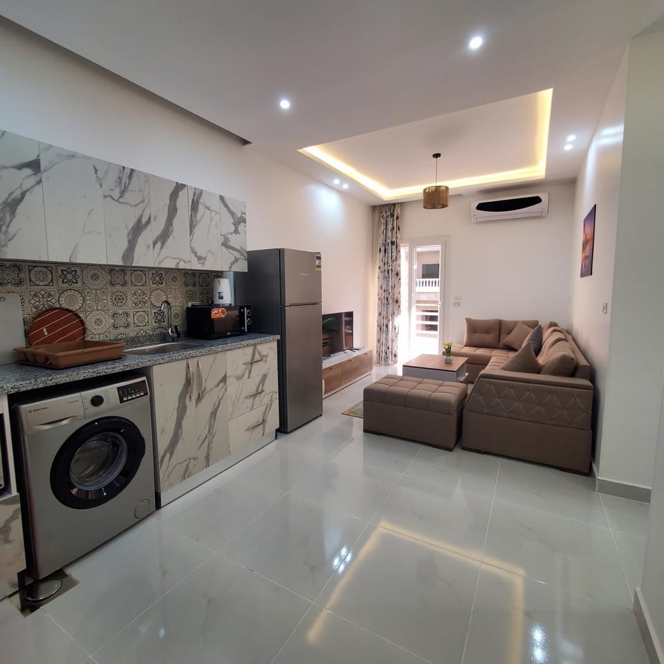 TV and multimedia, Kitchen or kitchenette, Living room, Seating area, stove, washing machine, air conditioner