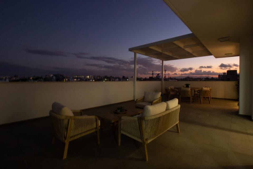 Night, View (from property/room), Balcony/Terrace, Living room, Seating area, Sunset