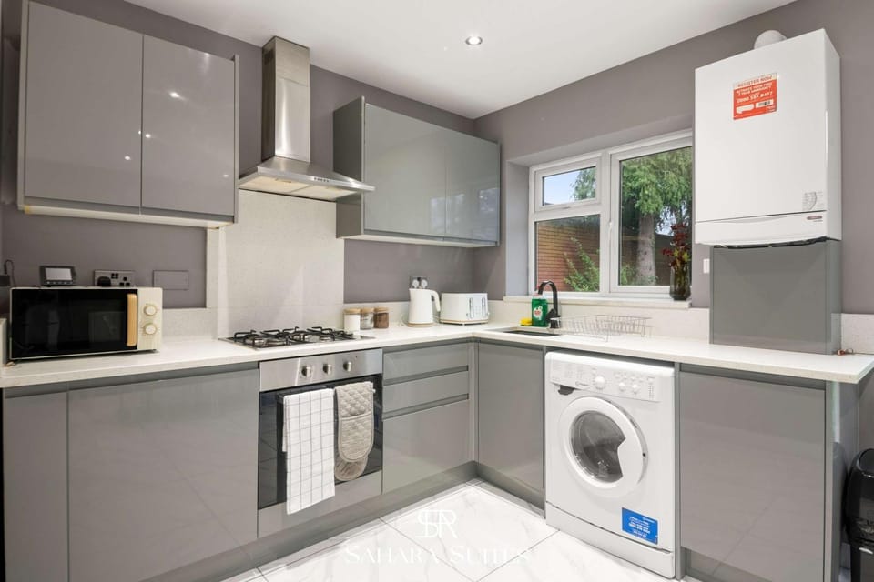 Kitchen or kitchenette, dishwasher, oven, stove, toaster, washing machine