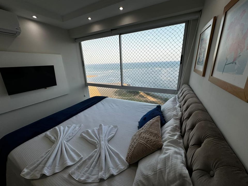 Bed, Natural landscape, TV and multimedia, Seating area, Bedroom, Sea view
