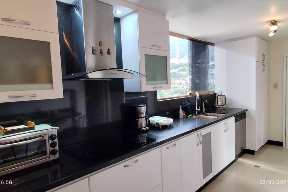 Kitchen or kitchenette, dishwasher, oven, stove