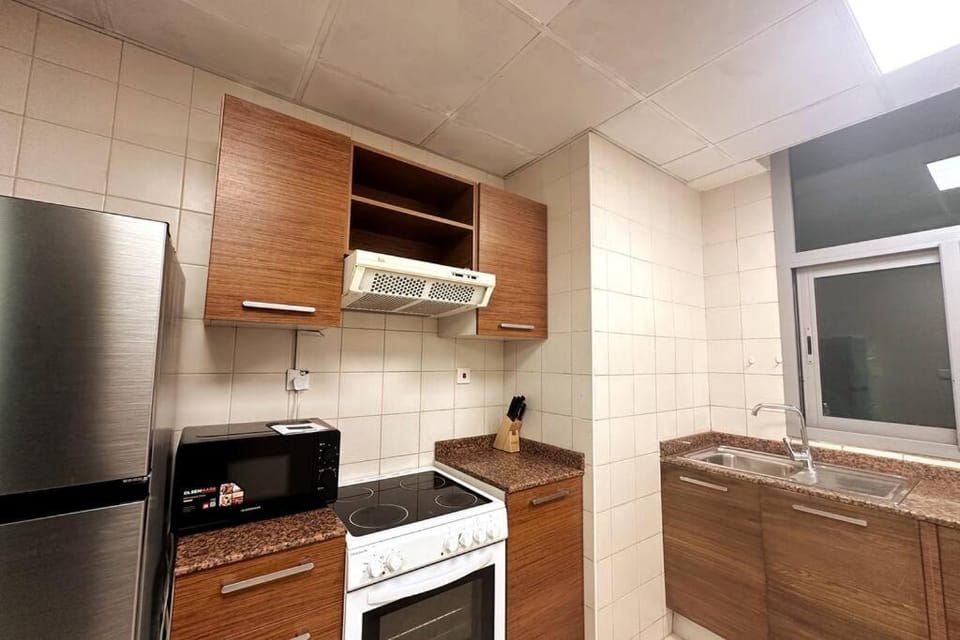 Kitchen or kitchenette, dishwasher, oven, stove
