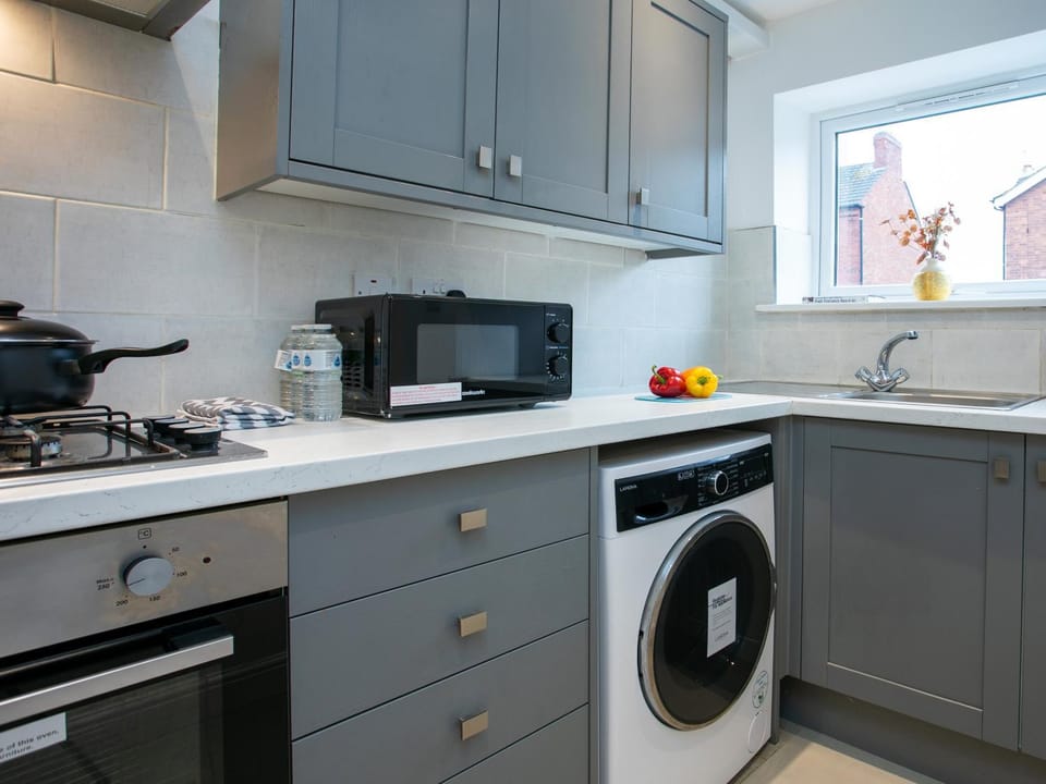 Kitchen or kitchenette, oven, stove, toaster, washing machine