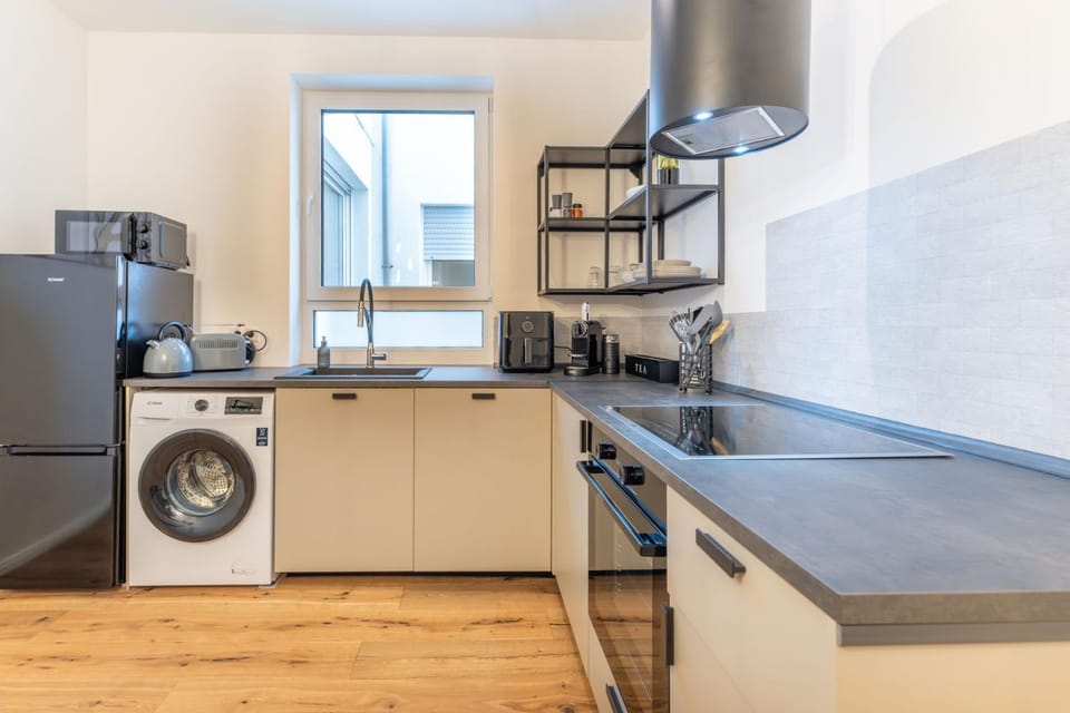 Kitchen or kitchenette, dishwasher, oven, stove, toaster, washing machine