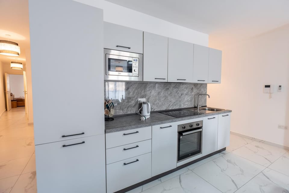 Kitchen or kitchenette, dishwasher, oven, stove