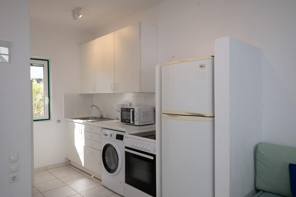 Kitchen or kitchenette, dishwasher, oven, stove, toaster, washing machine