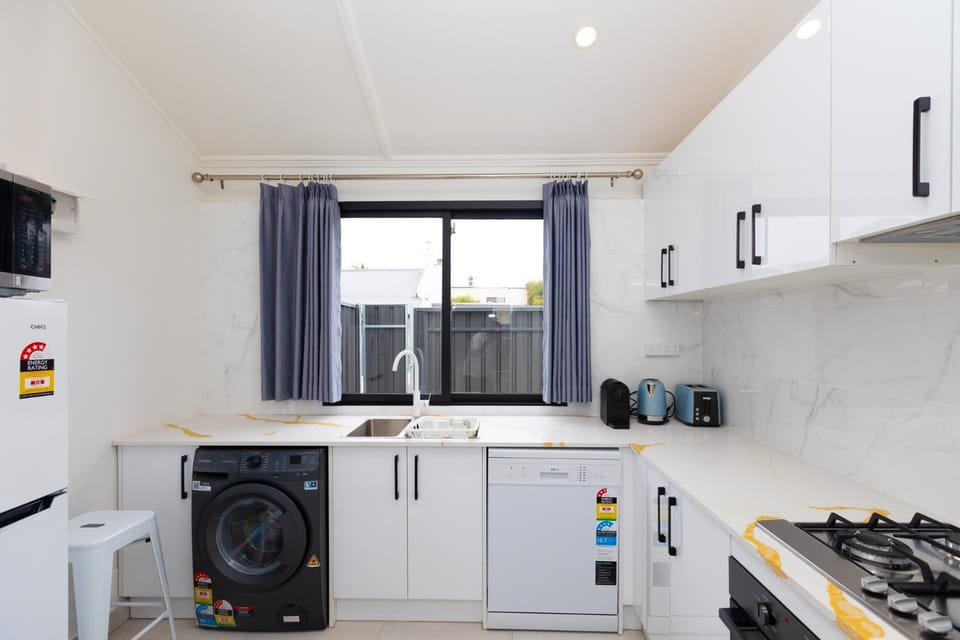 Kitchen or kitchenette, dishwasher, oven, stove, toaster, washing machine, dryer