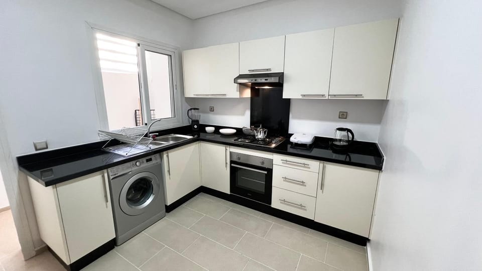Kitchen or kitchenette, dishwasher, oven, stove, washing machine