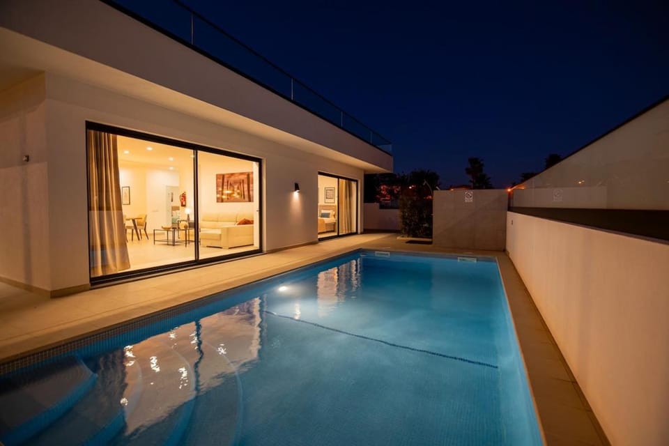 Property building, Night, Pool view, Swimming pool, sunbed