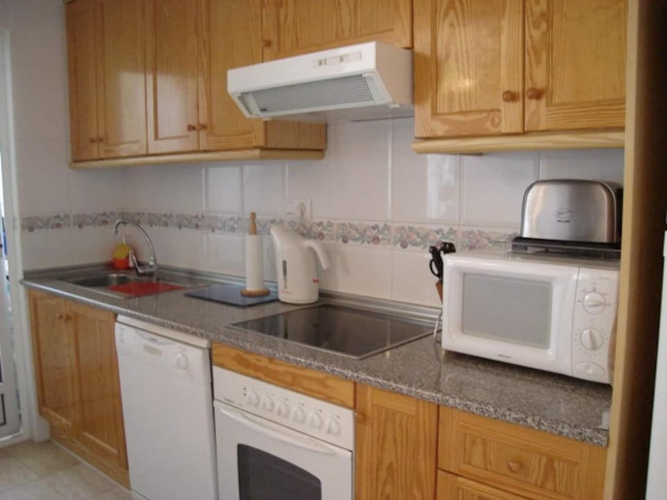 Kitchen or kitchenette, dishwasher, microwave, oven, stove, toaster