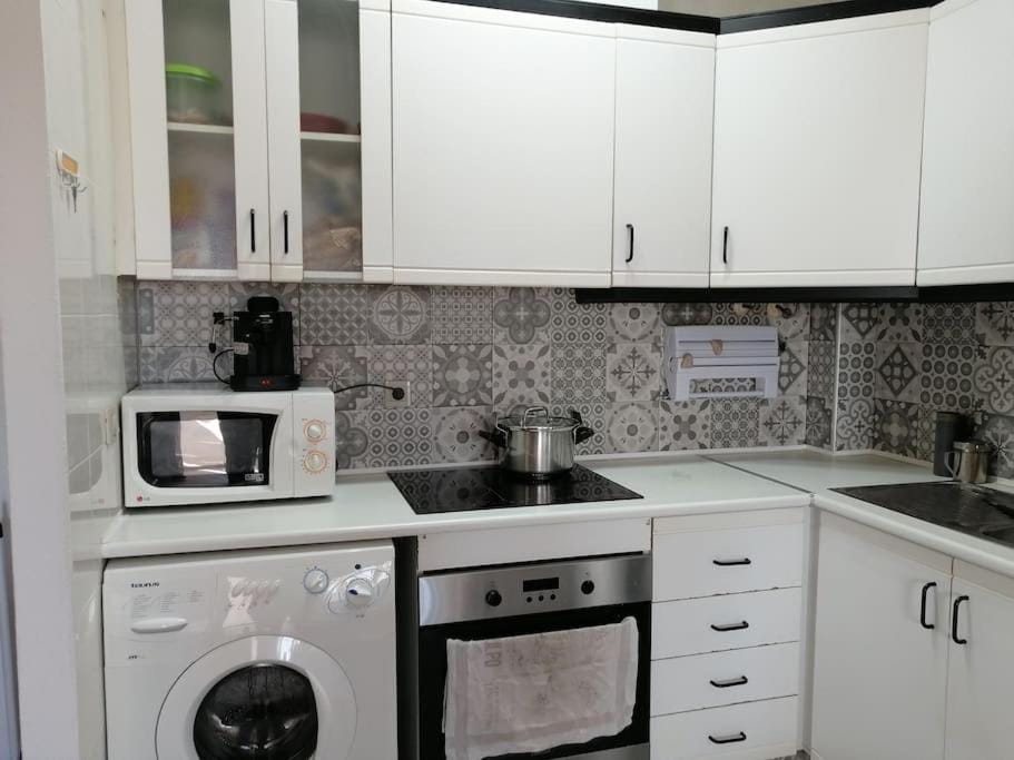 Kitchen or kitchenette, oven, stove, washing machine