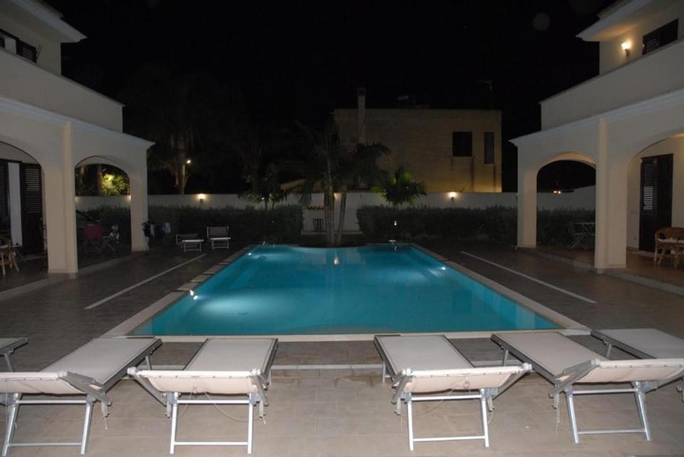 Patio, Night, Pool view, Swimming pool, sunbed
