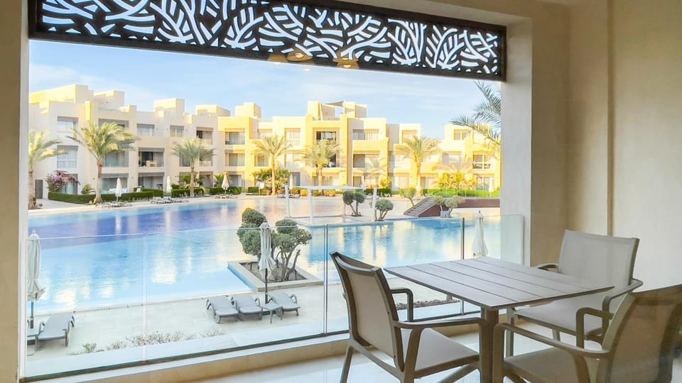 Property building, Patio, Living room, Seating area, Dining area, Pool view, Swimming pool