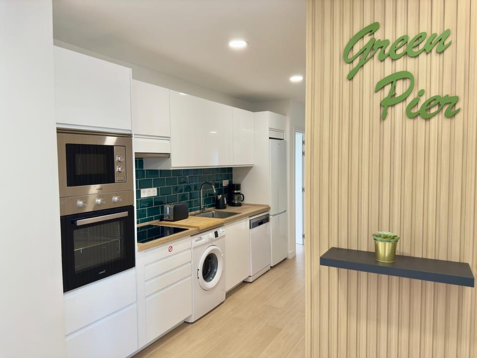 Kitchen or kitchenette, dishwasher, oven, stove, washing machine