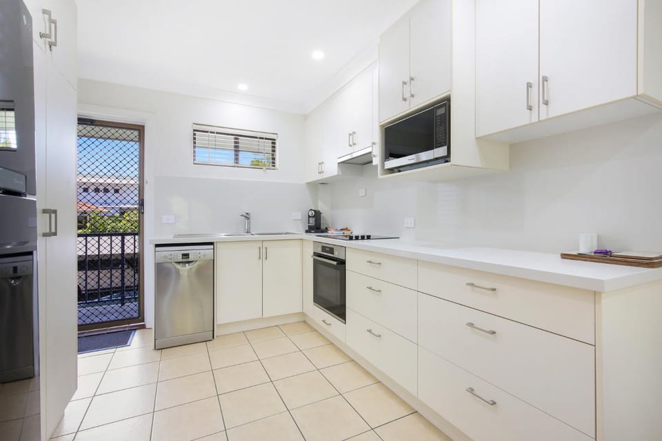 Kitchen or kitchenette, dishwasher, microwave, oven, stove