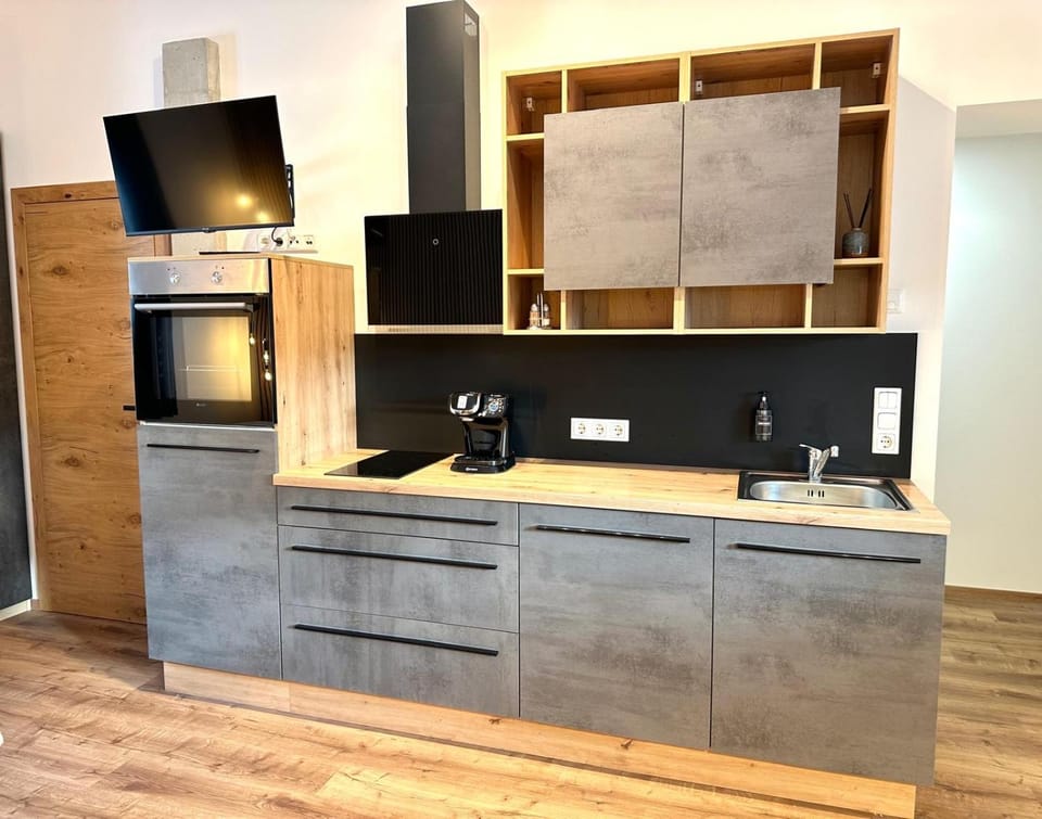 Kitchen or kitchenette, dishwasher, oven, stove