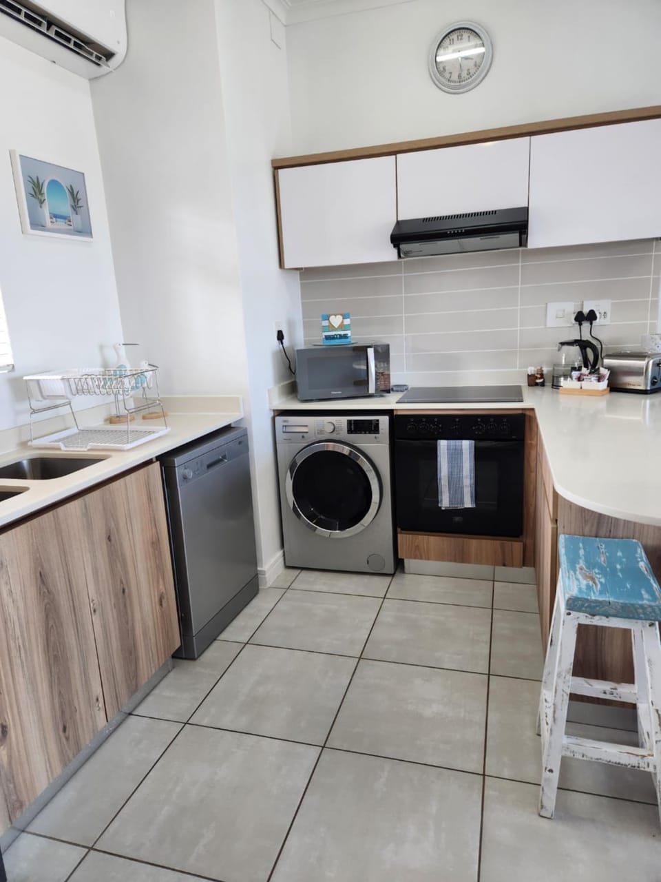 Kitchen or kitchenette, dishwasher, oven, stove, toaster, washing machine, dryer