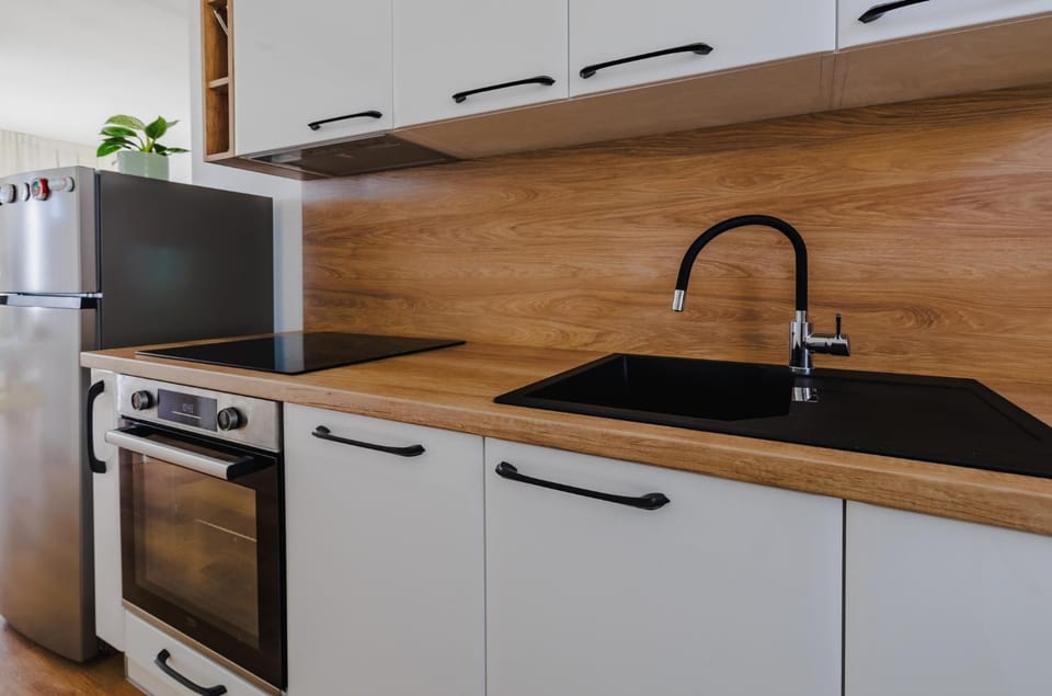 Kitchen or kitchenette, dishwasher, oven, stove