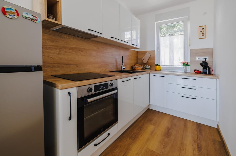 Kitchen or kitchenette, dishwasher, oven, stove
