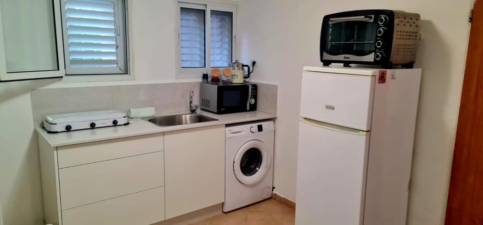 Kitchen or kitchenette, oven, stove, toaster, washing machine