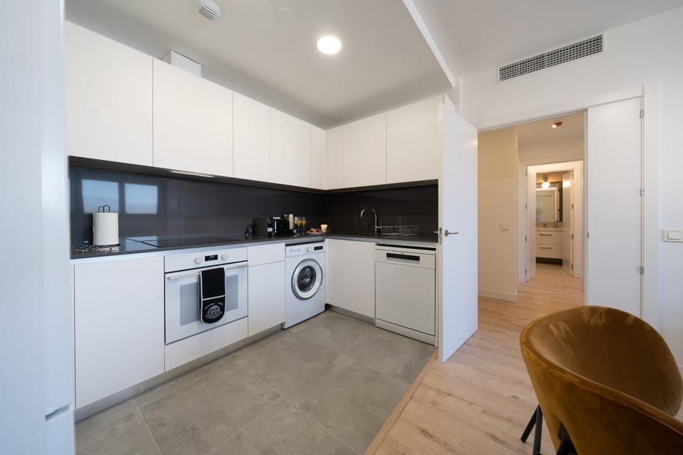 Kitchen or kitchenette, dishwasher, oven, stove, toaster, washing machine