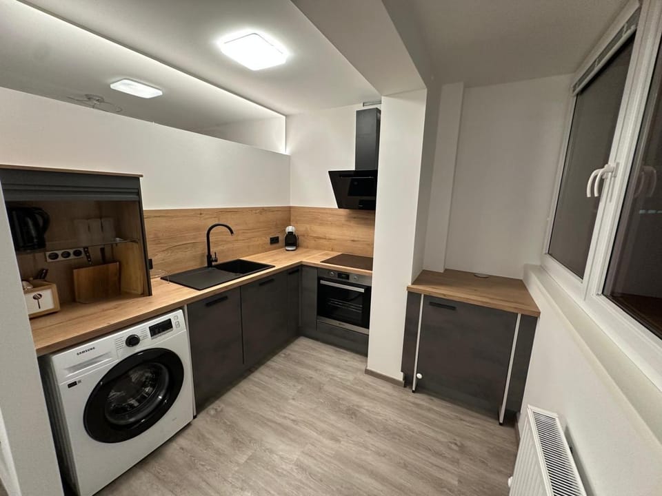 Kitchen or kitchenette, dishwasher, oven, stove, washing machine