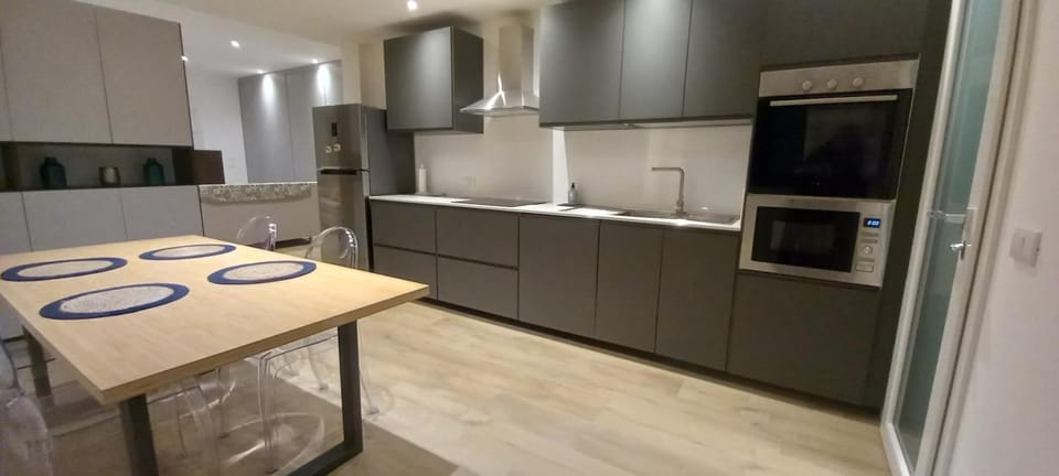 Kitchen or kitchenette, dishwasher, oven, stove
