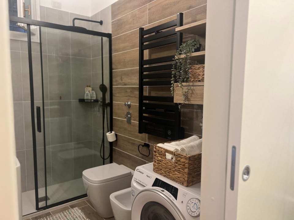 Shower, Toilet, Bathroom, bidet, towels, washing machine, dryer