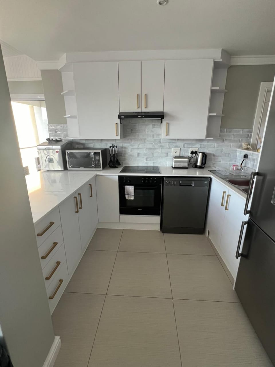 Kitchen or kitchenette, dishwasher, microwave, oven, stove, toaster