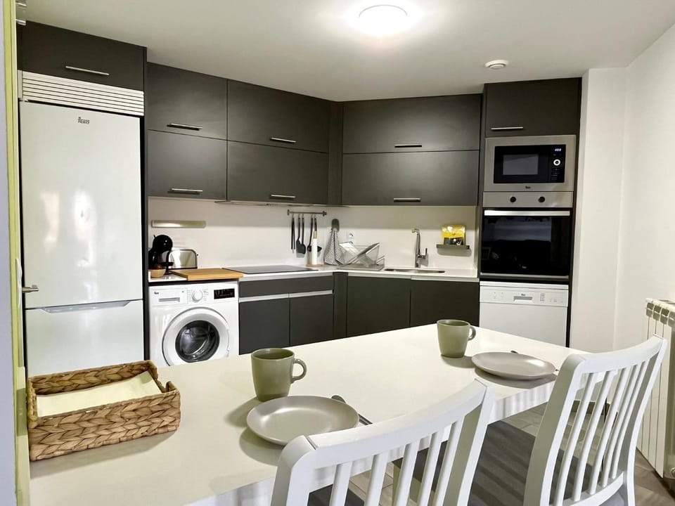 Kitchen or kitchenette, dishwasher, oven, stove, toaster, washing machine