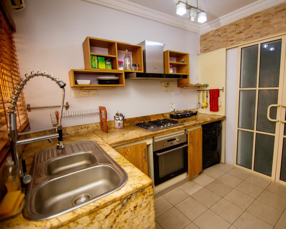 Kitchen or kitchenette, dishwasher, oven, stove