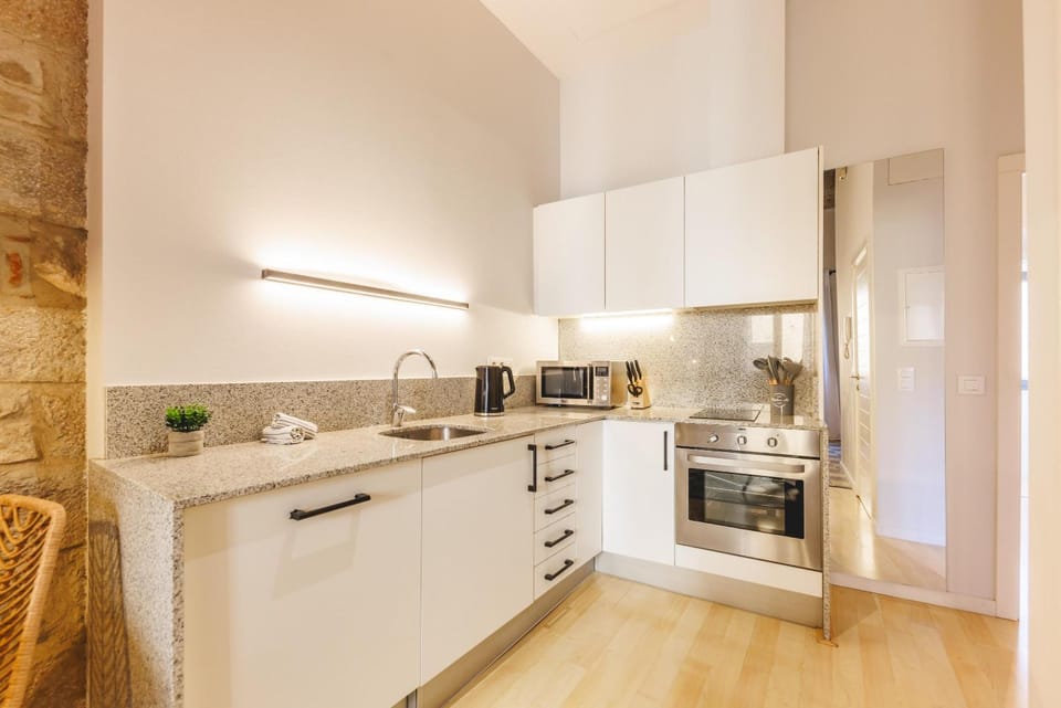 Kitchen or kitchenette, dishwasher, oven, stove