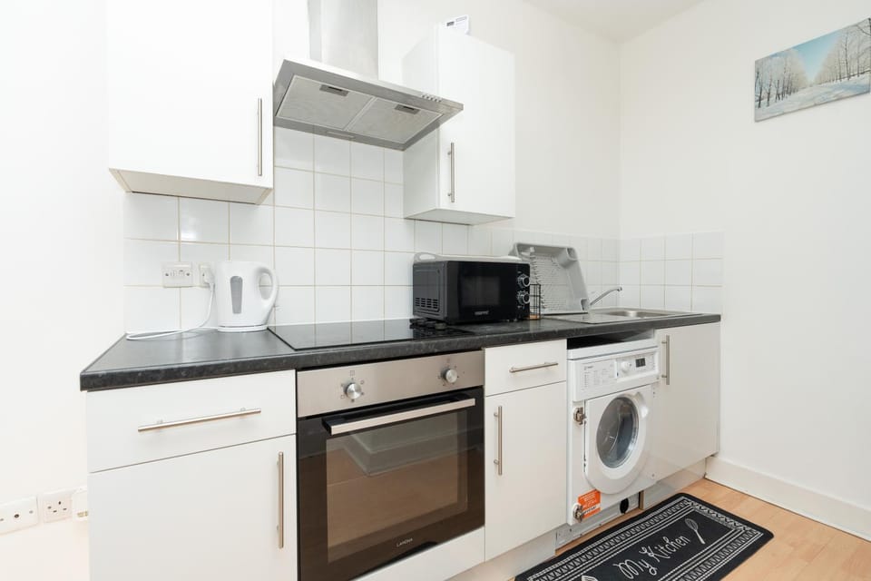 Kitchen or kitchenette, oven, stove, toaster, washing machine, dryer