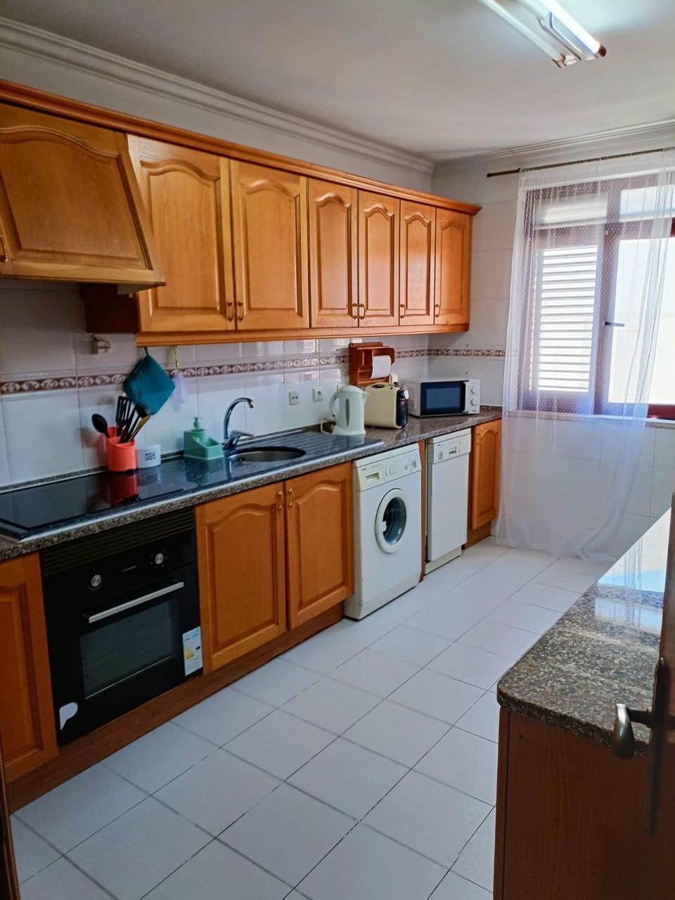Kitchen or kitchenette, dishwasher, oven, stove