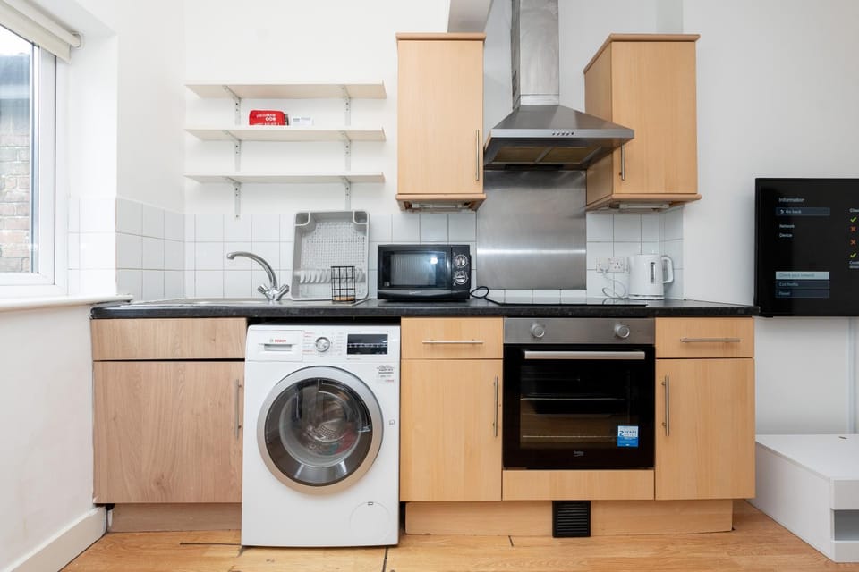 Kitchen or kitchenette, oven, stove, toaster, washing machine, dryer