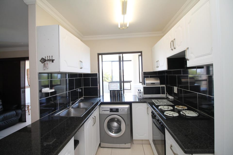 Kitchen or kitchenette, oven, stove, washing machine