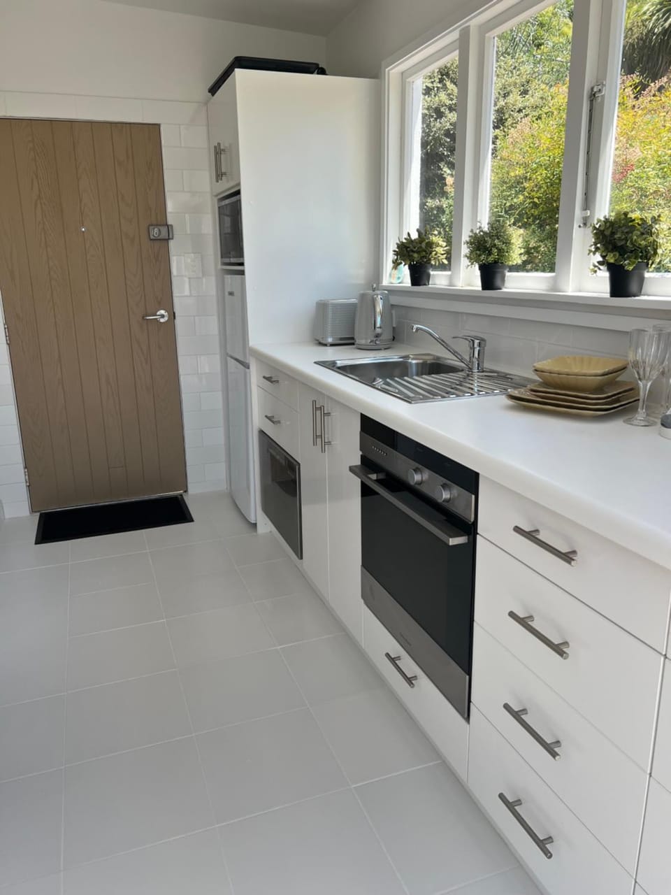 Kitchen or kitchenette, dishwasher, oven, stove