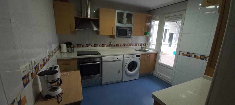 Kitchen or kitchenette, dishwasher, oven, stove, toaster, washing machine
