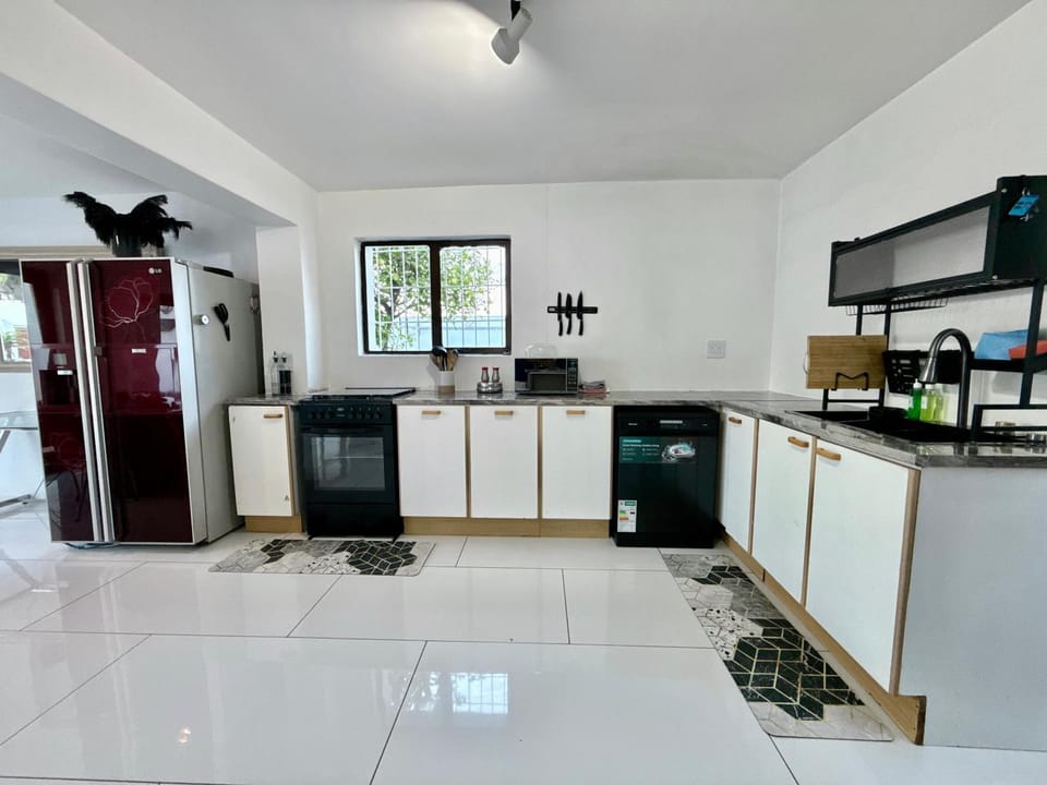 Kitchen or kitchenette, dishwasher, oven, stove