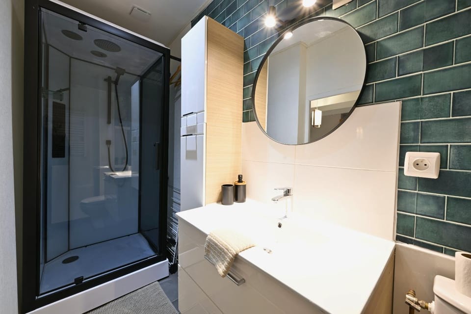 Shower, Toilet, Bathroom, hair dryier, towels, washing machine