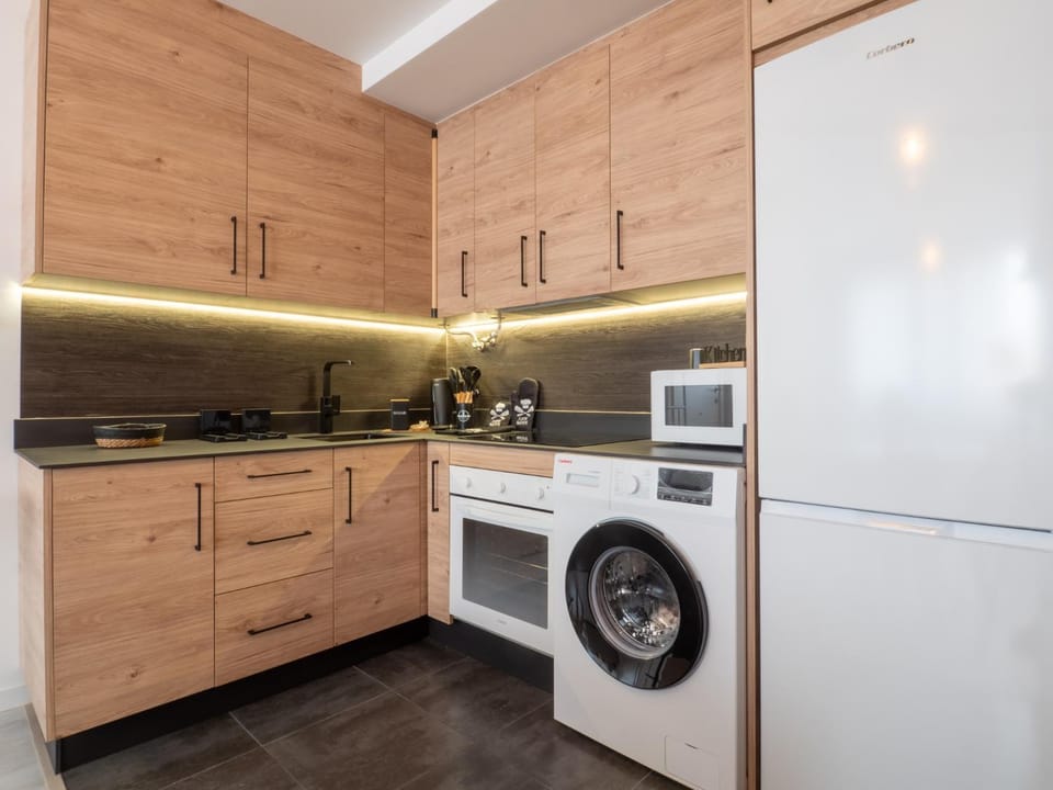 Kitchen or kitchenette, oven, stove, washing machine