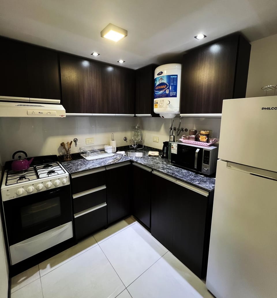 Kitchen or kitchenette, microwave, oven, stove